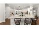 Modern kitchen with granite countertops, stainless steel appliances, and breakfast bar seating at 725 Danbridge Way, Roswell, GA 30076