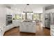 Well-lit kitchen with a center island, stainless steel appliances, and hardwood floors at 725 Danbridge Way, Roswell, GA 30076