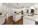 Spacious kitchen featuring white cabinetry, a large island, and hardwood floors at 725 Danbridge Way, Roswell, GA 30076