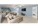 Well-lit living space offering comfortable seating, built-in cabinets and a mounted television at 725 Danbridge Way, Roswell, GA 30076
