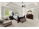 Beautifully appointed main bedroom with comfortable seating, trey ceiling, and natural light at 725 Danbridge Way, Roswell, GA 30076