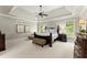 Spacious main bedroom featuring a trey ceiling, large windows, and stylish furniture at 725 Danbridge Way, Roswell, GA 30076
