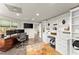 Bright office with built-in shelving, a large desk, and a view to the backyard at 725 Danbridge Way, Roswell, GA 30076