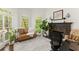 Sunlit office space with a cozy fireplace and large windows at 725 Danbridge Way, Roswell, GA 30076
