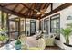 Cozy screened-in porch with ceiling fan, comfortable seating, and views of the surrounding landscape at 725 Danbridge Way, Roswell, GA 30076