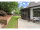 An exterior shot of a home with a beautiful screened in porch, a patio, and a retaining wall at 725 Danbridge Way, Roswell, GA 30076
