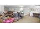 An open-concept attic living space featuring a sofa, bed, side tables, and inflatable pools at 820 Wilson Nw Rd, Atlanta, GA 30318