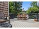 Back deck with outdoor seating, flowers, and a dark wood railing at 820 Wilson Nw Rd, Atlanta, GA 30318