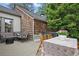 Back deck with outdoor seating, flowers, and a view of the wooded backyard at 820 Wilson Nw Rd, Atlanta, GA 30318