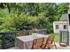 Landscaped back deck with outdoor seating, flowers, and dark wood railings at 820 Wilson Nw Rd, Atlanta, GA 30318