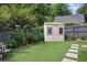 Lush backyard features a charming playhouse and manicured lawn, perfect for Gathering fun at 820 Wilson Nw Rd, Atlanta, GA 30318