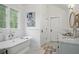 Bathroom featuring a soaking tub, wainscoting, and neutral design at 820 Wilson Nw Rd, Atlanta, GA 30318
