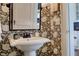 Charming bathroom showcasing wallpaper, a pedestal sink, and modern fixtures at 820 Wilson Nw Rd, Atlanta, GA 30318