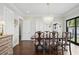 Light-filled dining room with modern chandelier and wood floors provides an elegant ambiance at 820 Wilson Nw Rd, Atlanta, GA 30318