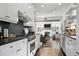 Gourmet kitchen featuring stainless steel appliances, custom cabinets, and a view into the living space at 820 Wilson Nw Rd, Atlanta, GA 30318