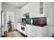 Bright kitchen with stainless steel range, white cabinets, and hardwood floors adjacent to dining room at 820 Wilson Nw Rd, Atlanta, GA 30318