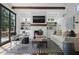 Stylish living room featuring custom built-ins, fireplace, and doors leading to an outdoor seating area at 820 Wilson Nw Rd, Atlanta, GA 30318
