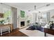 Bright living room featuring a fireplace, stylish decor, and hardwood flooring at 820 Wilson Nw Rd, Atlanta, GA 30318
