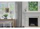 Sunlit living room featuring a fireplace, designer curtains, and hardwood flooring at 820 Wilson Nw Rd, Atlanta, GA 30318