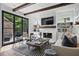 Bright and airy living room with hardwood floors, white stone fireplace, and access to outdoor spaces at 820 Wilson Nw Rd, Atlanta, GA 30318