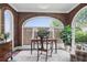 Sunroom/office featuring brick walls, arched windows, and elegant furnishings at 820 Wilson Nw Rd, Atlanta, GA 30318