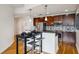 Modern kitchen featuring stainless steel appliances, dark cabinets, and a stylish breakfast bar with seating at 950 W Peachtree Nw St # 904, Atlanta, GA 30309