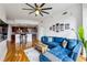 Bright living room featuring a blue couch, wood floors, and an open layout to the modern kitchen at 950 W Peachtree Nw St # 904, Atlanta, GA 30309