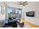Inviting living room featuring a comfortable blue couch, wood floors, and cityscape views through large windows at 950 W Peachtree Nw St # 904, Atlanta, GA 30309