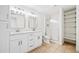 Bright bathroom with double sinks, walk-in shower, white cabinets and tile floor at 121 Brendylynn Trce, Woodstock, GA 30188