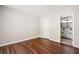 Bedroom with hardwood floors, neutral paint and view to the bathroom at 121 Brendylynn Trce, Woodstock, GA 30188