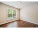 This bedroom features hardwood floors, light-colored walls, and a window at 121 Brendylynn Trce, Woodstock, GA 30188