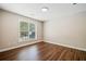 Cozy bedroom with hardwood floors, neutral walls, and a street view from the window at 121 Brendylynn Trce, Woodstock, GA 30188