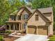 Charming two-story home boasts a stone and brick facade, two car garage and a beautifully landscaped front yard at 121 Brendylynn Trce, Woodstock, GA 30188