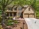 Charming two-story home boasts a stone and brick facade, two car garage and a beautifully landscaped front yard at 121 Brendylynn Trce, Woodstock, GA 30188