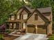 Charming two-story home boasts a stone and brick facade, two car garage and a beautifully landscaped front yard at 121 Brendylynn Trce, Woodstock, GA 30188