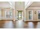 Bright foyer with gleaming hardwood floors, high ceilings, and decorative molding at 121 Brendylynn Trce, Woodstock, GA 30188