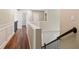 Hallway on second floor with wood floors and a view of staircase at 121 Brendylynn Trce, Woodstock, GA 30188