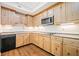 Kitchen features wood cabinets, stainless steel appliances, and tile countertops at 121 Brendylynn Trce, Woodstock, GA 30188