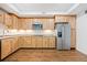 Kitchen with stainless steel appliances and light wood cabinetry at 121 Brendylynn Trce, Woodstock, GA 30188