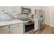 This kitchen features stainless steel appliances, granite countertops, and decorative backsplash at 121 Brendylynn Trce, Woodstock, GA 30188