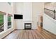 Inviting living room with fireplace, large windows, and hardwood floors, perfect for gatherings at 121 Brendylynn Trce, Woodstock, GA 30188