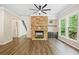 Bright living room with stone fireplace, hardwood floors, and seamless access to the outdoor deck at 121 Brendylynn Trce, Woodstock, GA 30188