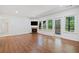 Spacious living room with wood floors, fireplace, and large windows at 121 Brendylynn Trce, Woodstock, GA 30188