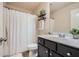 Well-lit bathroom with a modern vanity, toilet, and shower with patterned curtain at 2212 Knoxhill Se Vw, Smyrna, GA 30082