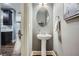Powder room featuring pedestal sink and accent mirror, adjacent to the kitchen at 2212 Knoxhill Se Vw, Smyrna, GA 30082