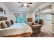 Large bedroom featuring a projector screen, ceiling fan, home office, and sitting area at 2212 Knoxhill Se Vw, Smyrna, GA 30082