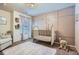Charming Bedroom featuring a crib, plush decor, and pink paneled walls at 2212 Knoxhill Se Vw, Smyrna, GA 30082