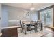 Gray dining room showcasing dining table, doors to backyard, and wall decor at 2212 Knoxhill Se Vw, Smyrna, GA 30082