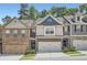 Charming townhome with stone accents, neutral siding, and attached two-car garage nestled in a well-manicured community at 2212 Knoxhill Se Vw, Smyrna, GA 30082