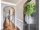 Welcoming foyer featuring an arched doorway, neutral paint, wood floors, and front door with wreath at 2212 Knoxhill Se Vw, Smyrna, GA 30082